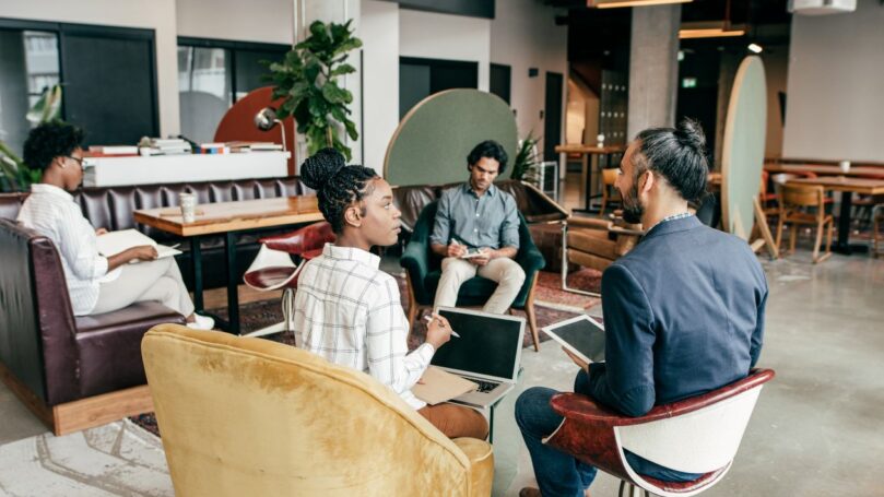 Entrepreneurs at work in a common area of a creative workplace.