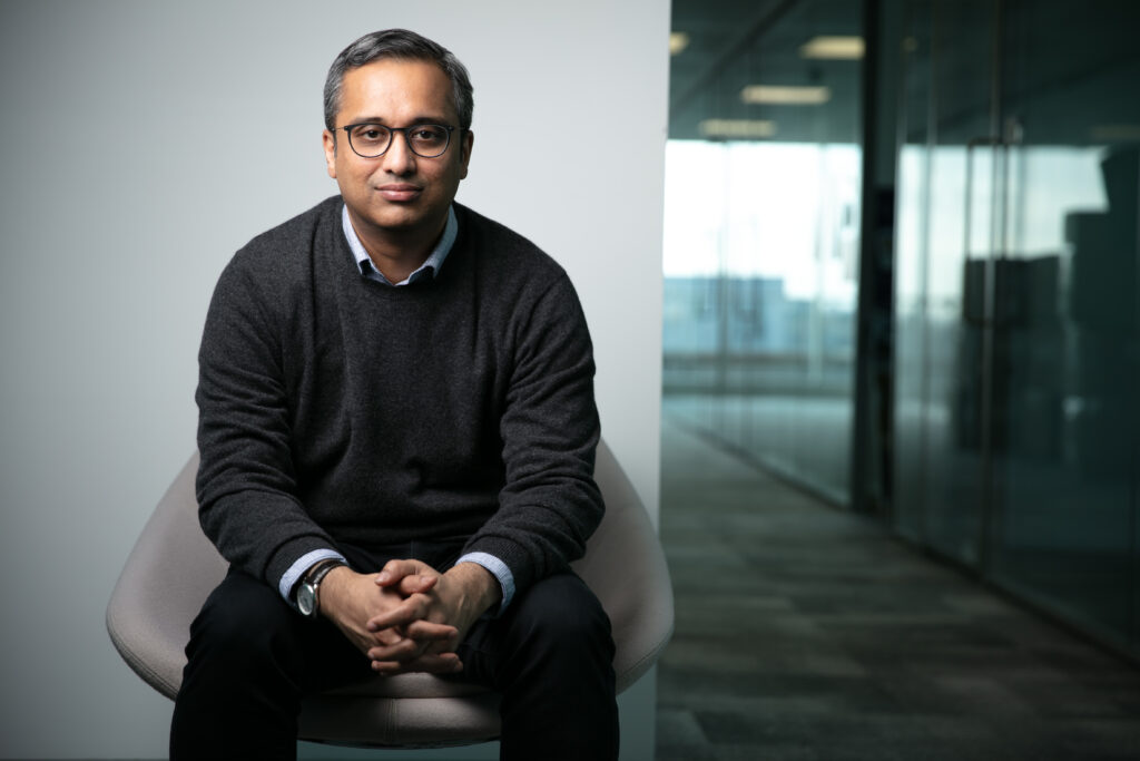 Photo of Aditya Nori sat on a chair